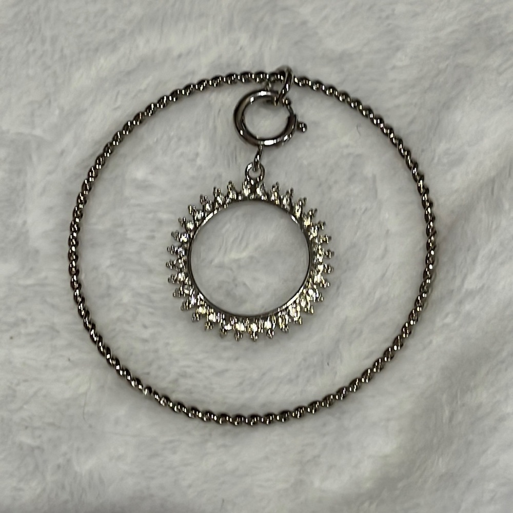 Silver tone circle sun charm bracelet with rhinestones